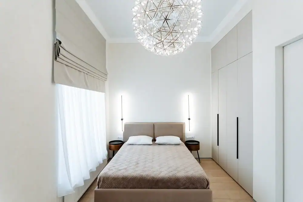 Elegant bedroom with modern window shades and stylish decor.